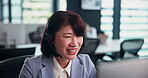 Call center, computer and woman talking with headset for customer service, virtual assistance and IT support. Help desk, mature japanese consultant and microphone for friendly advice, FAQ and explain