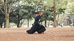 Man, Japanese and sword in nature for martial arts, skill development and demonstration. Asian warrior, kendo and bamboo weapon in park for traditional culture, technique and heritage in Hiroshima