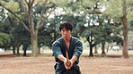 Man, Japanese and sword in woods for martial arts, skill development or demonstration. Asian warrior, kendo or bamboo weapon in nature park for traditional culture, technique or heritage in Hiroshima