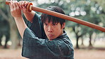 Man, Japanese or sword in nature for kendo, skill development or confidence. Asian warrior, martial arts or outdoor with bamboo weapon for traditional culture, fighting stance or history in Hiroshima