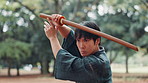 Man, Japanese and outdoor with sword for martial arts, skill development and demonstration. Asian warrior, kendo and bamboo weapon in park for traditional culture, technique and heritage in Hiroshima