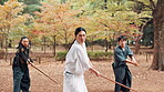 Aikido, bamboo and sword with Sensei in forest for martial arts exercise, practice or training. Discipline, fight and weapon with serious Japanese people in nature for class, kendo or self defense