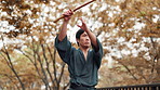 Martial arts, japanese man and bamboo sword for kendo in forest with traditional practice and skill development. Culture, serious samurai and weapon for fighting technique, self defense and attack