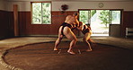 Sumo, wrestling and training with Japanese people in ring for fight, tournament and competition. Culture sports, traditional and game with asian men in temple for festival, ritual and heritage