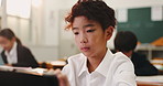 Reading, kid and tablet in classroom for education, learning and language development. Japanese boy, student and technology in school with elearning app, online resources and innovation for growth