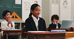 Talking, applause and Asian students in classroom with answer, knowledge and quiz in lesson. School, kids and Japanese girl with victory, success and well done for education, learning and studying