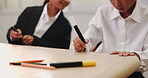 Group, kids and classroom with writing, notes and paper in education, growth and development. Japanese, students and drawing for tuition in art curriculum or module for knowledge, answer and learning