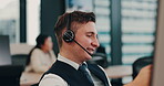 Call center, headset and male person in agency for customer service, technical support or consulting. Man, microphone and telecommunication for advice, conversation and feedback as help desk operator