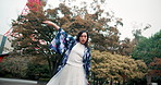 Asian woman, motion and dance in park for culture, rhythm and traditional performance for elegance. Person, art and spiritual dancer moving in nature for heritage, kimono fashion and garden in Japan