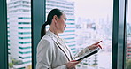 Woman, tablet or pointing at window for business, urban development or investment opportunity in office. Mature investor, tech or typing in Japanese agency for planning, economy research or checklist