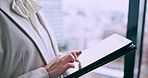 Woman, hands and tablet at window for business, update schedule and planning in office. Trader, tech and typing in Japanese agency for stock market research, investment opportunity or online feedback