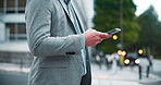 City, phone and hands of business man for travel, morning commute and walking in Japan. Professional, corporate and worker on smartphone on social media for communication, typing email and contact