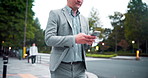 Walking, phone and business Asian man in city for travel, commute and journey in Japan. Online direction, corporate and worker on smartphone on social media for communication, typing email or contact