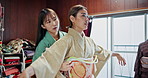 Kimono, fashion and women fitting belt together at boutique with choice, decision and agreement. Girl, customer and traditional Japanese clothes with pattern design, culture or help dressing in store