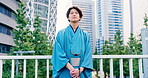 Man, thinking and fashion in city for travel, commute or motion blur on busy street in Japan. Asian person, kimono or calm on Tokyo bridge with traditional style, heritage pride or indigenous culture