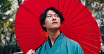 Umbrella, thinking and Japanese man in city with traditional, fashion, robe and custom clothes on street, Tokyo, morning and parasol with holiday, urban trip and travel on vacation outdoor on break