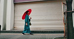 Umbrella, walking and Japanese man in city with traditional, fashion, robe and custom clothes on street, Tokyo, morning and parasol with holiday, trip and travel on pavement with vacation outdoor