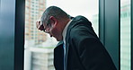 Mature businessman, depression and thinking by window with lost investment, bankrupt and stress at agency. Person, back and anxiety for economy, mental health and crisis at trading company in Japan