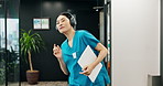 Nurse, energy and dancing with headphones at hospital for music, listening or radio podcast in corridor. Japanese, female person or healthcare assistant with headset for audio streaming at clinic