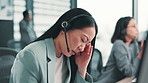Frustrated, asian woman or consultant with headache at call center for stress, anxiety or fatigue at office. Japanese, female person or agent with headset of migraine for burnout or vertigo at agency