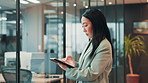 Asian woman, designer and writing with tablet at office for project, checklist or graphic design in corridor. Japan, female person or network with pen for online signature, development or report