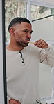Man, brushing teeth and mirror for hygiene in bathroom with bamboo toothbrush, dental wellness and shine. Male person, cleaning and oral care with fresh breath, morning routine and whitening at house