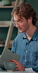 Man, reading notebook and laughing in office for funny plot development, proofreading article or creative process. Freelancer, writer and journal with comic feedback, story research or editing review