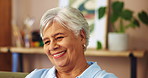 Senior woman, smile and thinking on sofa of happy memory, remember and laughing with nostalgia in living room. Retirement, person and thoughtful in home for reflection, relax and wondering on couch