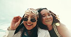Face, laughing and wink with friends on beach together in summer for holiday, travel or vacation. Portrait, playful and wind with happy women on topical island for bonding, love or weekend wellness