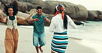 People, circle and dancing on beach outdoor for energy, freedom and summer vacation of travel reunion. Friends, playful and movement for rhythm, holiday fun and bonding together of tropical gathering