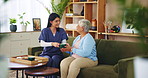 House, senior woman and caregiver with coffee, thank you and retirement with breakfast in lounge. Pensioner, nurse and elderly patient on sofa, herbal tea and smile with kindness, service and support