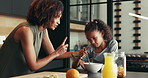 Scold, home or mom talking to kid for love, development or warning for teaching lesson in morning. Breakfast, mother or girl eating cereal in family kitchen for food discipline, meal or strict rules