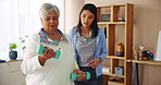 Dumbbells, fitness or physiotherapy with old woman and nurse in living room of retirement home. Exercise, recovery or rehabilitation with caregiver and senior patient in apartment for mobility
