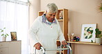 Senior woman, walking and support with walker for mobility aid or assistance at retirement home. Elderly, patient or person with a disability for movement, balance or physical activity in progress