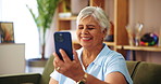 Elderly woman, phone and wave in video call for contact, communication or happy in home. Senior person, mobile or smile in living room for connection, chat and gossip story with network in retirement