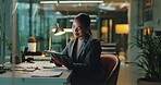 Investment, stock market and tablet with business woman in office at night for banking or trading. Economy, finance and money with employee in corporate workplace for asset or wealth management
