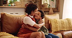 Woman, child and hug on sofa with love, affection and happiness in home living room. Family, smile and kid embrace for Mothers day with support, relationship development or bonding in house with care
