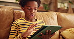 Gaming, relax and tablet with black child on sofa in living room of home for education or development. Learning, study and technology with African boy in apartment for online challenge or game