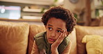 Sad, stress and child thinking of depression, bullying trauma and anxiety for mistake on living room sofa. African kid, home and unhappy boy with mental health crisis, lonely orphan or abuse victim