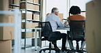 Men, discussion and computer with logistics, boxes and planning for delivery schedule in office at warehouse. People, mentor and conversation with back, package and distribution with supply chain job