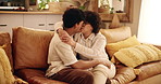 Home, couch and couple with kiss for love, connection and bonding together with affection in lounge. Happy people, man and woman with embrace for commitment, trust and hug in relationship in house