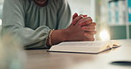 Closeup, prayer hands and person reading bible in spiritual religion for peace, guidance and learning. Forgive, education or worship in home with praise, scripture and gratitude with faith and book