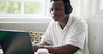 Student, cafe and black man with headphones on laptop for online learning, studying and education. School, coffee shop and student listen to music on computer for research, assignment and university