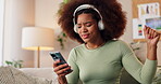 Music, phone and dance with woman on sofa for streaming service, headphones and sound app. Social media, listening and hip hop with person in living room at home for digital, audio and subscription