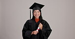 Woman, university student and happy with certificate in studio for achievement and success in Japan. Female person, face and excited with qualification on graduation and victory on gray background