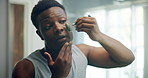 Man, jade roller and bathroom in home for skincare in mirror, cosmetics or wellness in morning. African person, facial or stone tools for health, process and transformation with dermatology at house