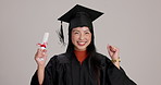 Face, university and woman with celebration, graduation and happiness on gray studio background. College, Asian person and student with achievement, education and goals with smile, success or degree