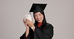 Piggy bank, smile and face of graduate in studio with money saving, investment or tuition fees. Happy, funds and portrait of Japanese woman student with cash growth for graduation by gray background.