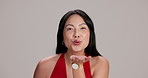 Blow a kiss, face and love with Japanese woman in studio on white background for valentines day. Portrait, romance and smile of happy Asian person with gesture for affection, dating or expression