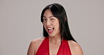 Flirting, wink and face of woman, studio and romantic for anniversary, smile and happy for valentines day. Grey background, space and Asian person with personality, confident and expression in Japan